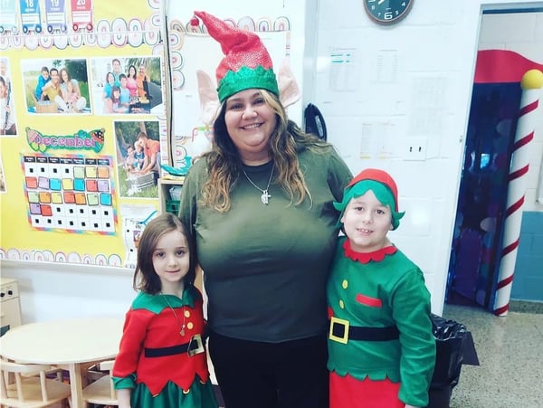 teacher with students in Christmas costumes